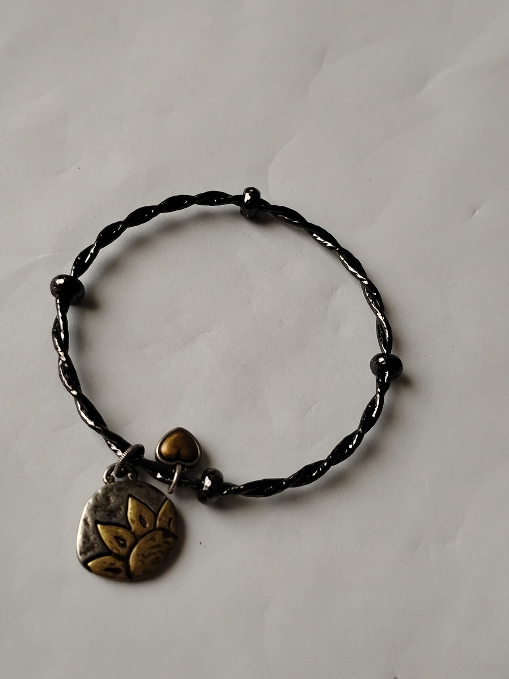 Brighton Black Twisted Bangle with Gold Lotus and Heart Charms
